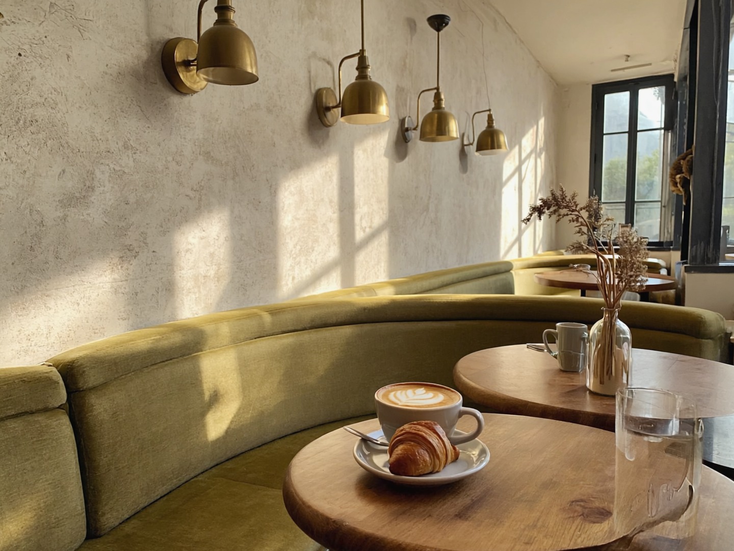 Warm café interior and inviting table setting for the fictional Olive Table website